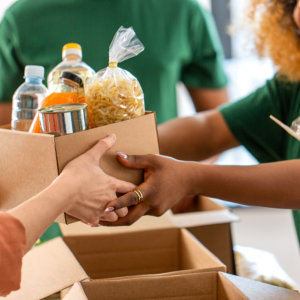 woman handing out boxes