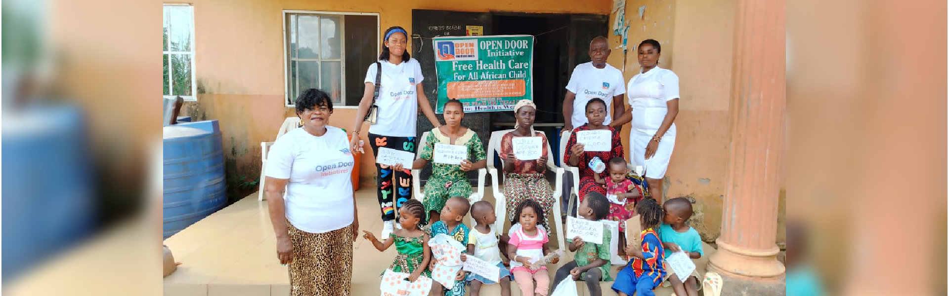 adults smiling and kids holding up a paper